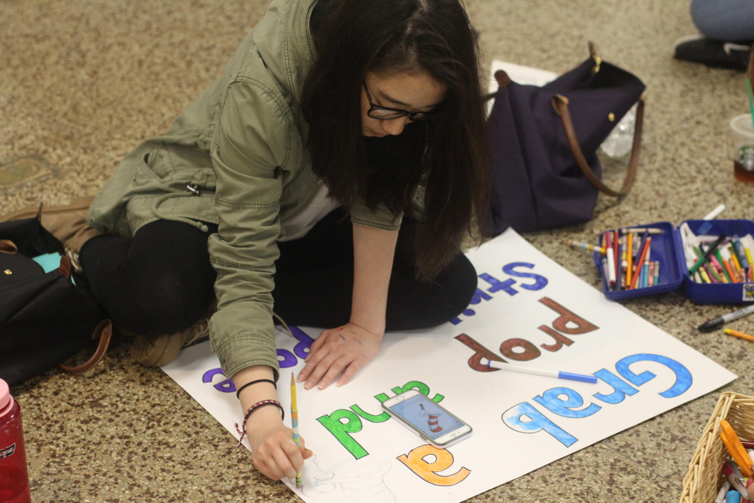 Relay for Life Committee members prepare posters for fundraising efforts.