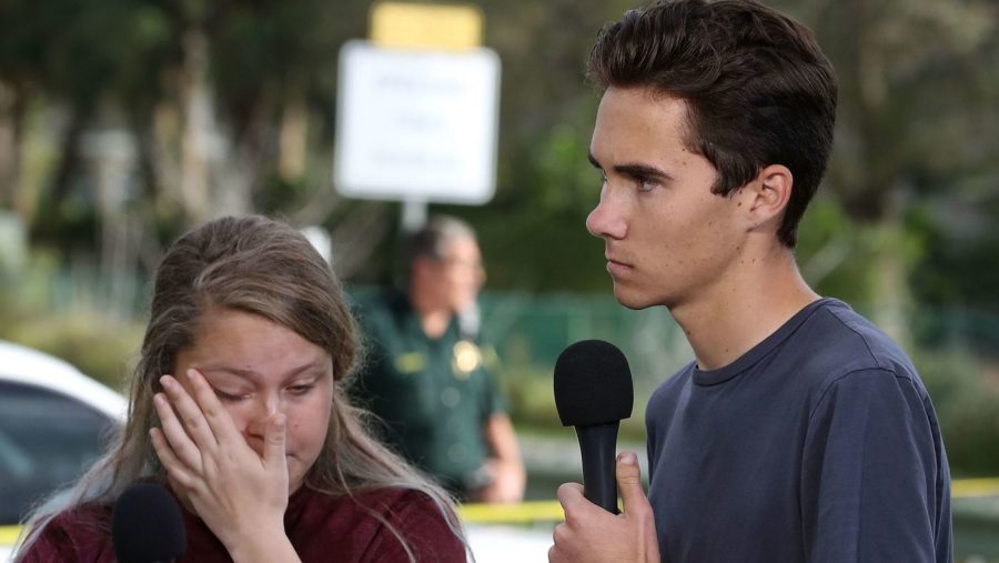 Students+Kelsey+Friend%2C+left%2C+and+David+Hogg+speak+about+the+mass+shooting+at+Marjory+Stoneman+Douglas+High+School+on+Feb.+15%2C+2018.+%28LA+Times%2FMark+Wilson+%2F+Getty+Images%29