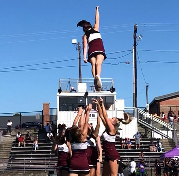 Freshman flyer, Carli Imparato stunting with her team at the South Carolina game in August.