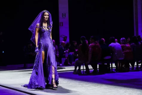 Bella Hadid walks across the catwalk dressed in Versace